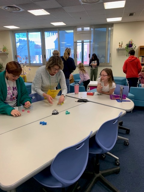 Students playing games in the library during Literacy & Math Family Night