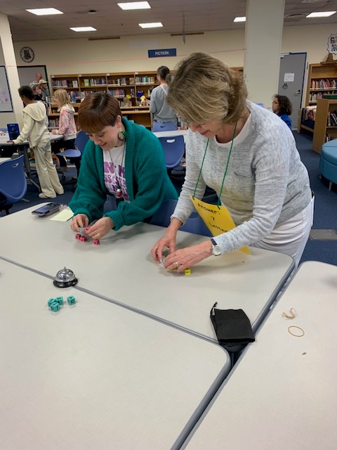 Students playing games in the library during Literacy & Math Family Night